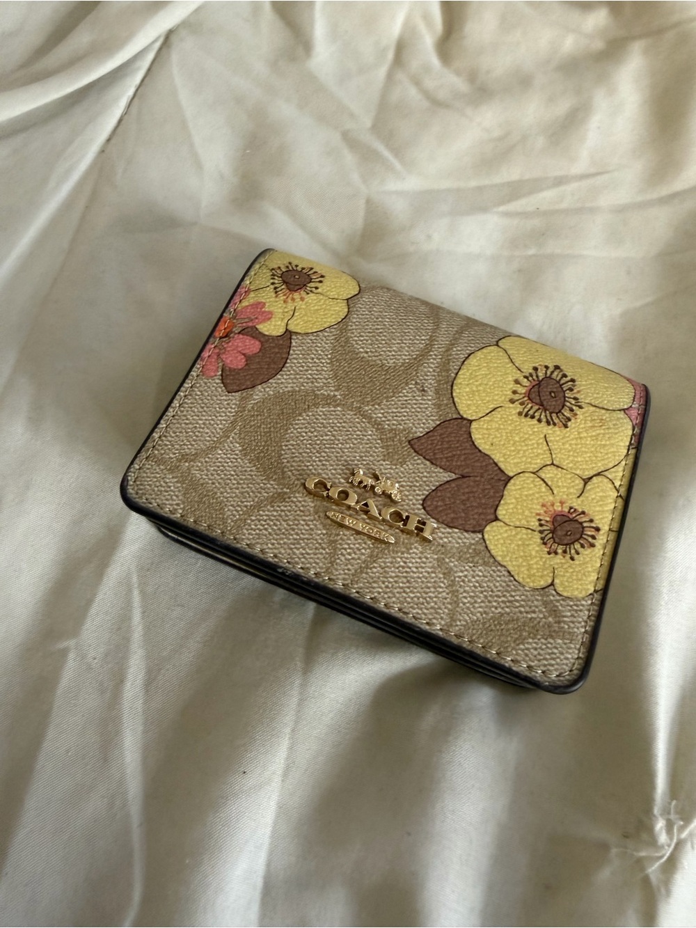 Coach Beige Signature Compact Wallet with Yellow Floral Accents